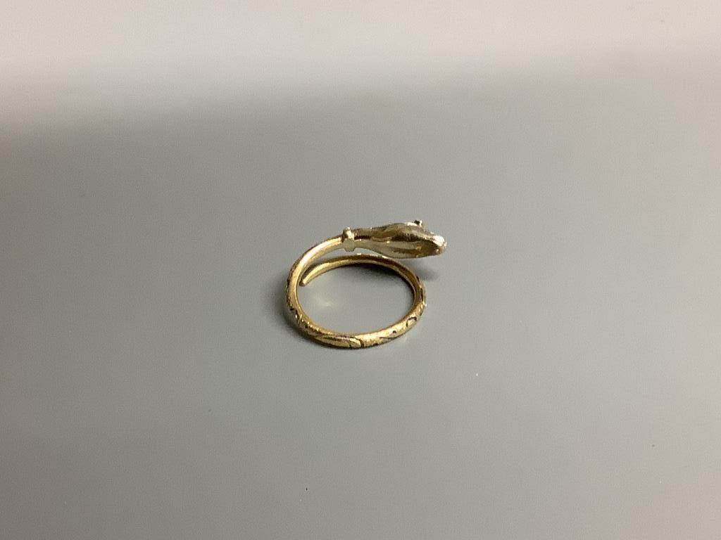 A yellow metal, blue enamel(a.f.) ruby and diamond chip set serpent ring, size L, gross 4.5 grams.